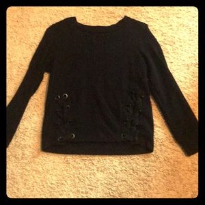 Black sweater with two braids going down